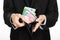 Money and business theme: a man in a black suit holding a purse with paper money Euro isolated on white background in studio