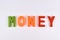 Money colored word sign with alphabet on white background