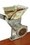 Money concept with dollar banknotes in meat grinder taken closeup.
