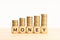 Money concept. Wooden blocks with text and rising stacked coins