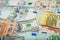 Money and finances concept. One hundred dollar new bill on colorful abstract background of Ukrainian, American and euro national