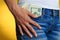 Money in front pocket and women\'s hand on it