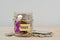 Money jar full of coins with violet ribbon and Donate label - Concept of Alzheimer, Pancreatic cancer, Epilepsy , Hodgkin`s
