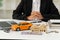 Money, keys and a small wooden house on the table, orange car and laptop. blurry background in the office The concept of leasing i