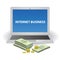 Money lying next to a laptop. Internet business illustration.