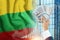 Money in a man`s hand against the background of the flag of Lithuania. Income of Lithuanians. Financial condition of Lithuanian