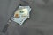 Money Pile Stuck Out Of Military Khaki Coat Pocket