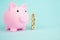 Money saving for future investment and retirement concept in 2021 year. Pink piggy bank with geometric wood blocks cube adt text