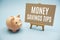 Money saving tips text message and piggy bank on blue background