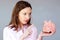Money savings stressed woman holding moneybox pink piggy bank