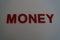 Money text in red on a plain white background