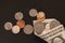 Money, US Dollars bank notes, penny, nickel, dime, quarter on black background. Finance and economy concept