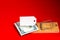 Money and a white paper lie in a mousetrap. Red background. Risk, financial insurance. Place for text