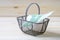 Moneybox, euro banknote in shopping basket