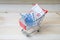 Moneybox, euro banknote in shopping cart