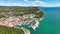 MONFALCONE, ITALY - APRIL, 2023: Sailing yacht moored off the coast Adriatic sea in Italy at sunny day. Drone aerial