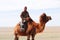 Mongolain nomadic herdsman on his camel