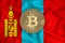 Mongolia flag, bitcoin gold coin on flag background. The concept of blockchain, bitcoin, currency decentralization in the country