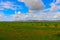 Mongolia steppe landscape of infinite grasslands under beautiful cloud in blue sly