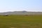 Mongolia steppe landscape of infinite grasslands under beautiful cloud in blue sly