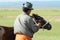 Mongolian man puts wooden bridle on foal to stop milking from animal`s mother in Harhorin, Mongolia.