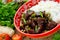 Mongolian meat in sauce with rice. Traditional Asian dish stir-fry