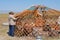 Mongolian men assemble yurt nomadic tent in steppe in Kharkhorin, Mongolia.