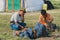 Mongolian men fix traditional horse saddle in front of the yurt nomadic tent entrance circa Kharkhorin, Mongolia.