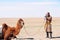 Mongolian nomadic herdsman with his camel