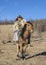 Mongolianman dressed in traditional clothing on a horse