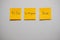 Monitor task of work concept, To do, In progress, Done Note reminder yellow sticker or post note on a white wall close up,.