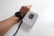 Monitoring blood pressure of patients using upper arm blood pressure monitor in the clinic examination room