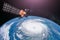 Monitoring hurricane. Satellite above the Earth makes measurements of the weather parameters and movement trajectory forecast.