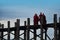 Monk of Burma walking cross over lake at U Bein Bridge