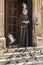 Monk feeding the pigeons in front of the Franciscan Monastery and Church, Dubrovnik, Croatia