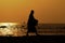 Monk on Hua Hin beach with silhouette