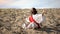 Monk in lotus pose raising hands to sky, praying to God in desert, meditation