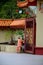 Monk opens main gate and readies Sam Poh Chinese Buddhist temple Cameron Highlands Malaysia