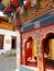 Monk peeping from the prayer wheel at Lhakhang Karpo, Paro, Bhutan