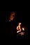 Monk portrait human face hold candle fire light and pray in darkness environment space vertical photography soft focus concept