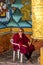 Monk at the prayer wheel