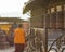 Monk praying at prayer wheels spinning them for good fortune.