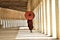 Monk with red umbrella walking in a buddhist temple