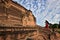 Monk with red umbrella walking in a buddhist temple