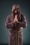 The monk in religious concept on gray background