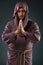 The monk in religious concept on gray background