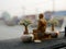 A monk statue being placed on a driving car dashboard in Thailand as the Thais believe that the statue save them from road acciden