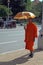Monk with umbrella