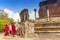 Monk walking in front of Vatadage Round House of Polonnaruwa ruin Unesco world heritage on Sri Lanka