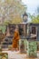 Monk walking in prayer among temples of sukhothai thailand